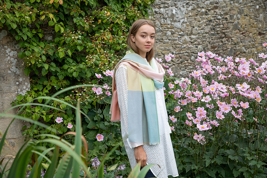 Model in garden wears rose pink, duck egg blue and green scarf 